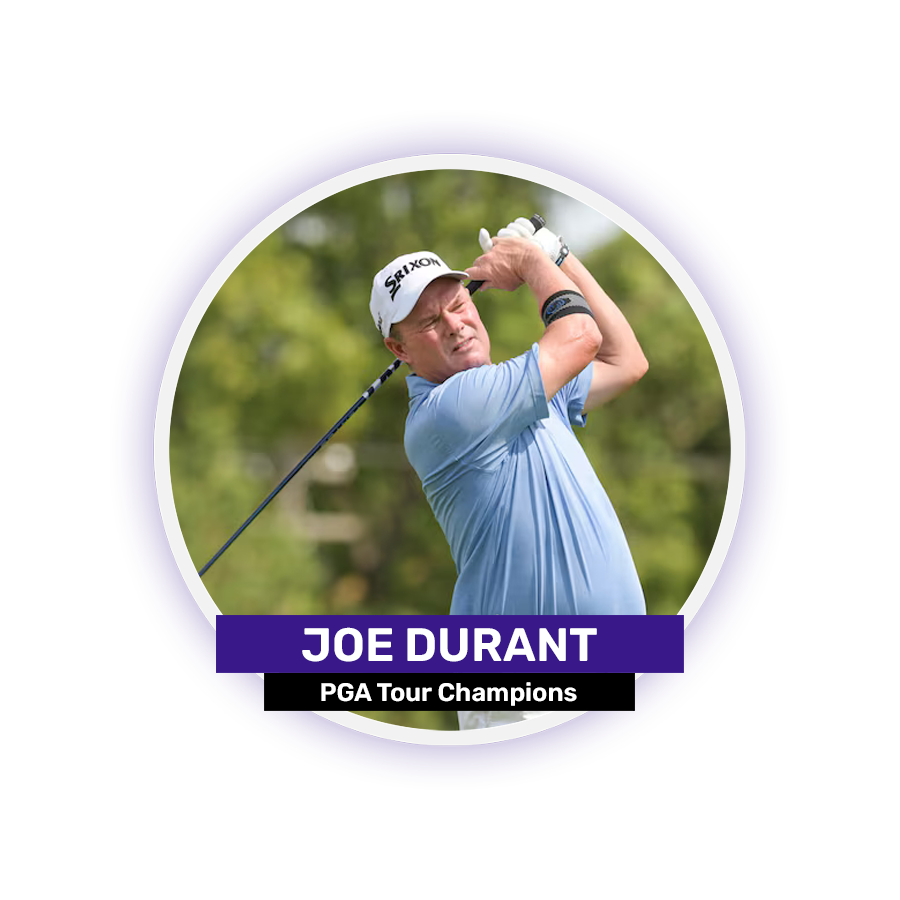 A man in a blue shirt and white cap swings a golf club outdoors.