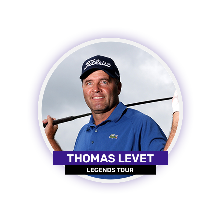 A man wearing a blue shirt and a cap holds a golf club over his shoulder in front of a cloudy sky.